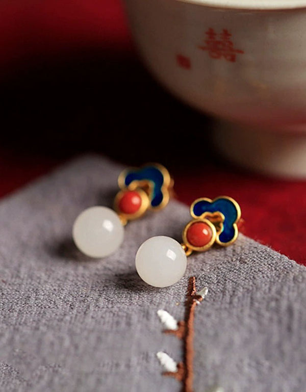 Pair of blue enamel red stone earrings with round white pearl drops in gold tone setting