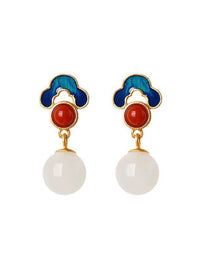 Pair of earrings with blue, red, and white elements on a white background