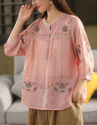 Side view of pink bohemian-style women’s embroidered cotton blouse with floral embroidery