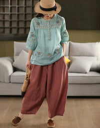 Front view of women’s blue bohemian embroidered cotton blouse with button details