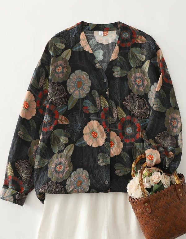 Woman wearing black floral V neck button blouse styled with light skirt for casual boho outfit