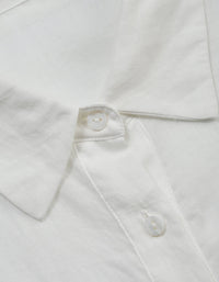 Close-up of a white shirt with buttons on a light gray background