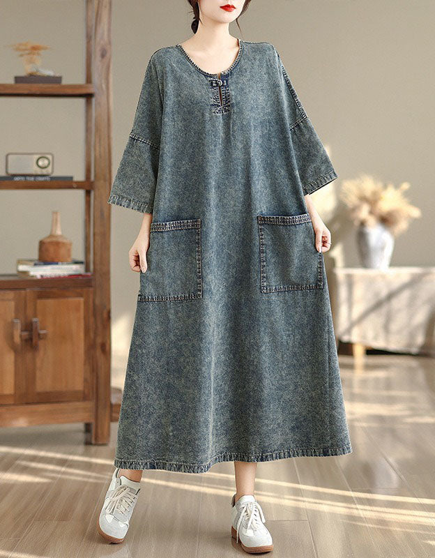 Side view of women’s denim maxi dress with loose fit and pockets