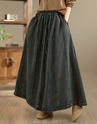 Side view of high waisted denim maxi skirt styled with brown shirt