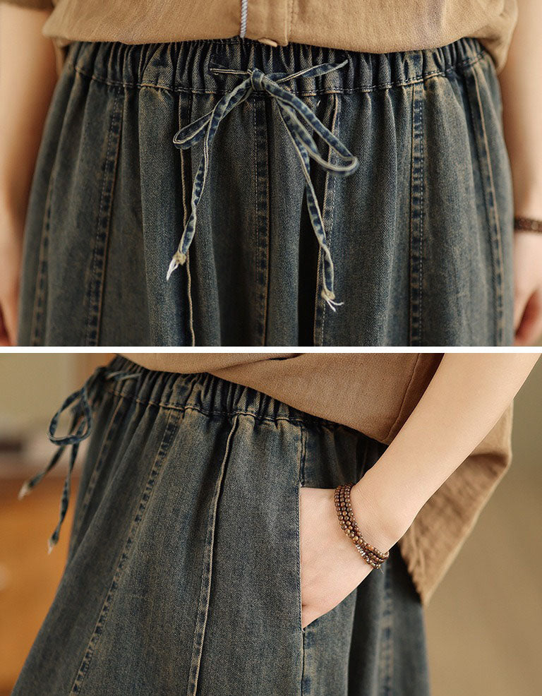 Close up of elastic drawstring waist on women’s long denim skirt