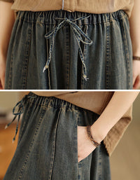 Close up of elastic drawstring waist on women’s long denim skirt