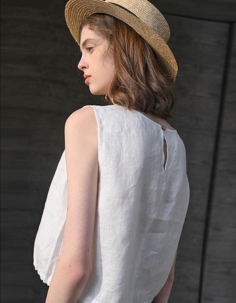 Back view of white minimalist sleeveless linen drawstring crop top women