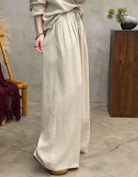 Side view of Women’s light beige linen pants with drawstring waist, wide-leg relaxed fit, breathable casual trousers for everyday wear