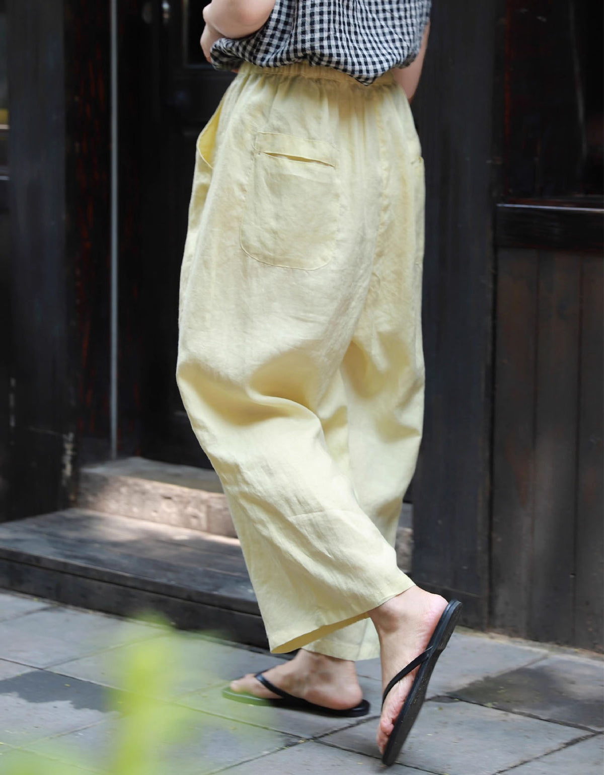 Back view of women styling breathable wide-leg cotton linen pants for casual summer look