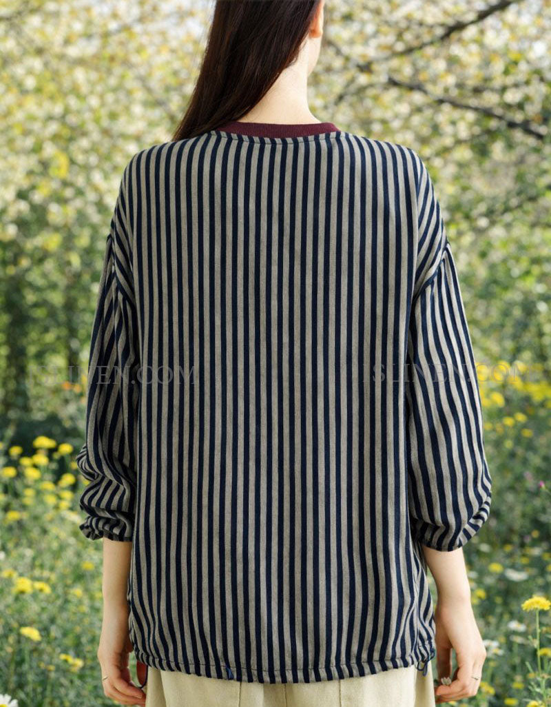 Back view of women’s striped blouse with burgundy collar