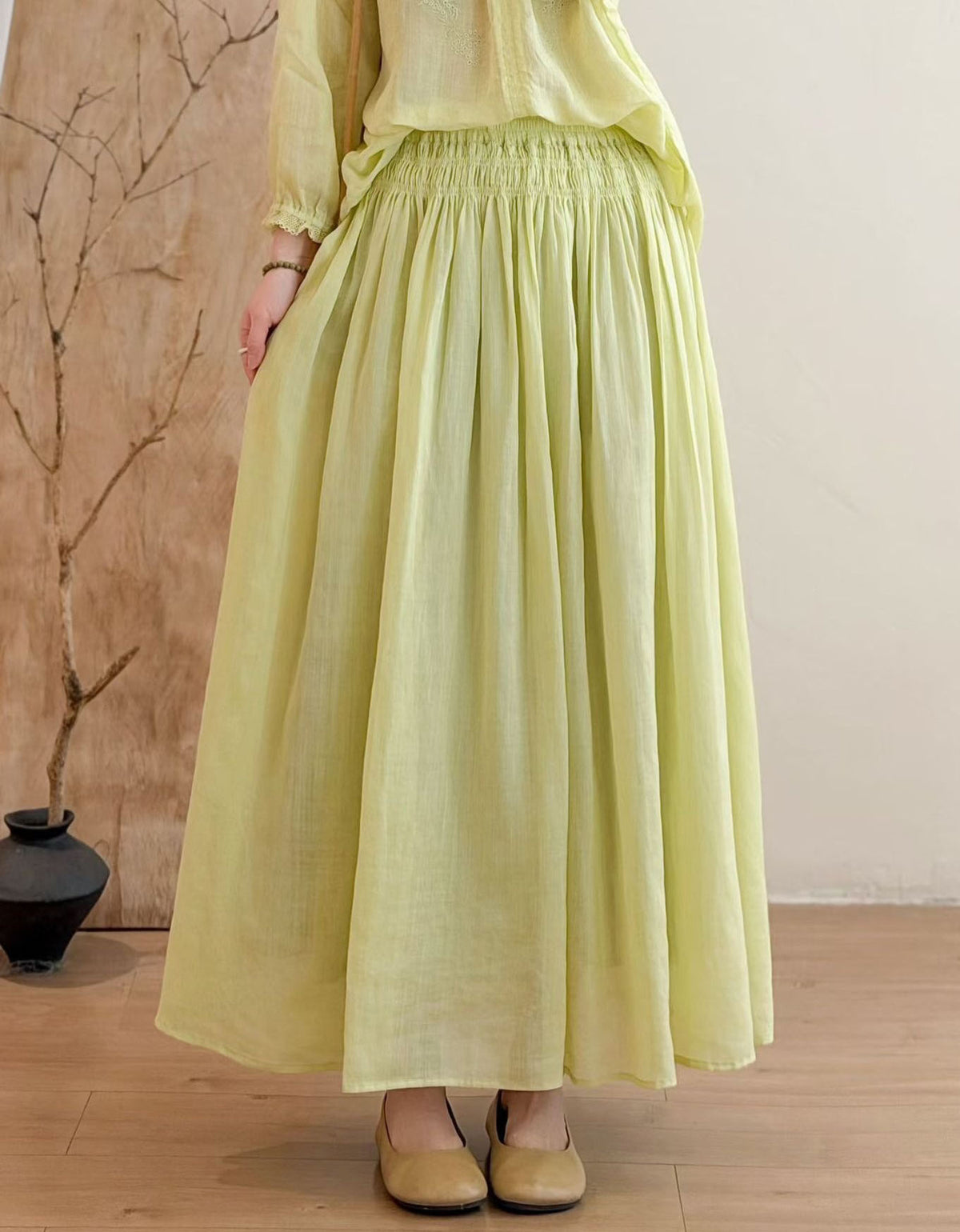Women wearing lime green flowy linen maxi skirt with elastic smocked waist