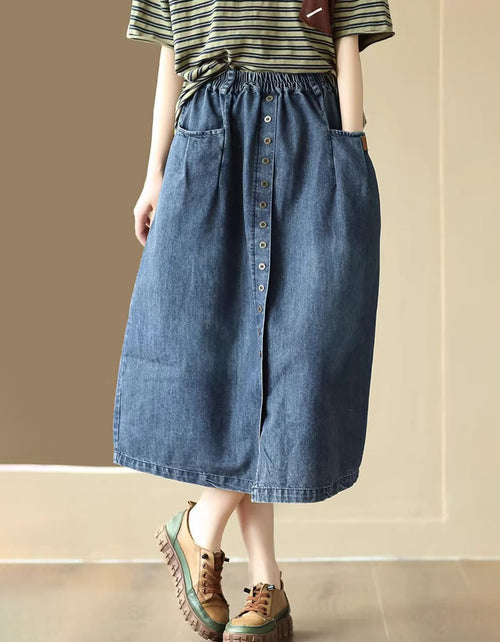 Women wearing denim midi skirt with button front and elastic waist