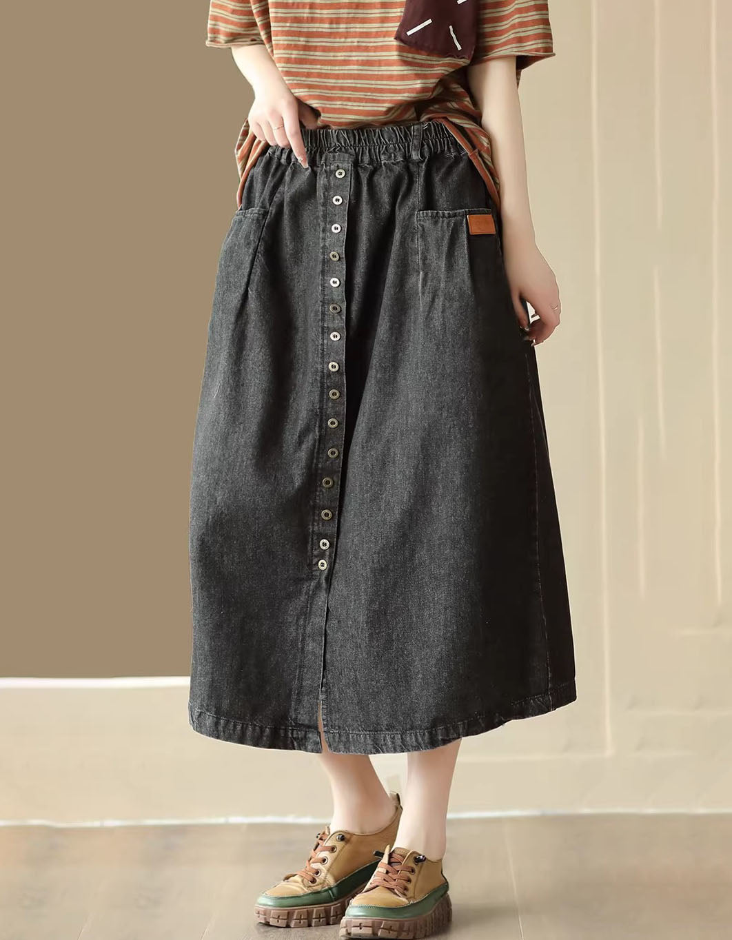Side view denim midi skirt showing pockets and elastic waistband