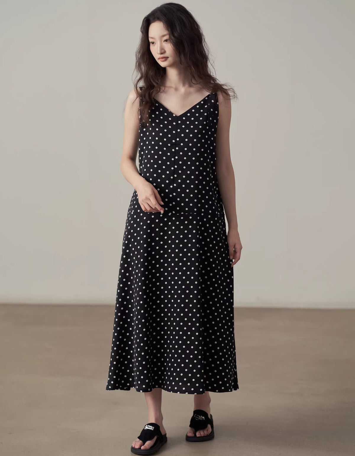 Women wearing black polka dot midi dress sleeveless