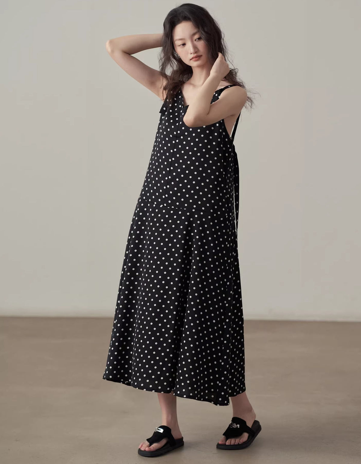 Casual black midi dress with white polka dots front view