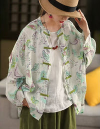 Side view of women’s floral linen blouse in green and white, lightweight breathable fabric with button closure, perfect for casual summer outfits