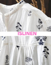 White dress with black floral embroidery on a hanger, featuring the brand 'ISLINEN'.