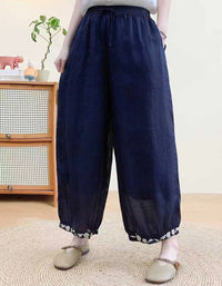 Soft lightweight linen harem trousers paired with casual flat shoes