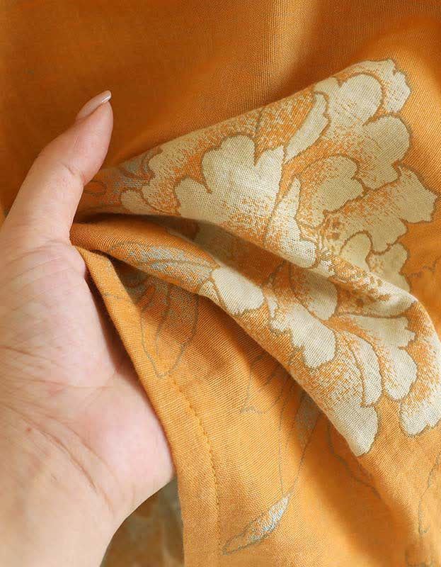 Close-up of the intricate weave of the cotton fabric on the mustard yellow top, showcasing its smooth finish and subtle texture