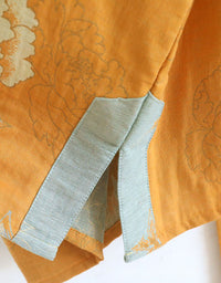 Close-up of the natural cotton fabric on the women’s floral embroidered top, offering a comfortable and airy feel