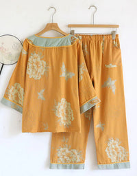 Back view of women’s floral embroidered two-piece set, casual outfit with top and pants in mustard yellow with elegant floral design