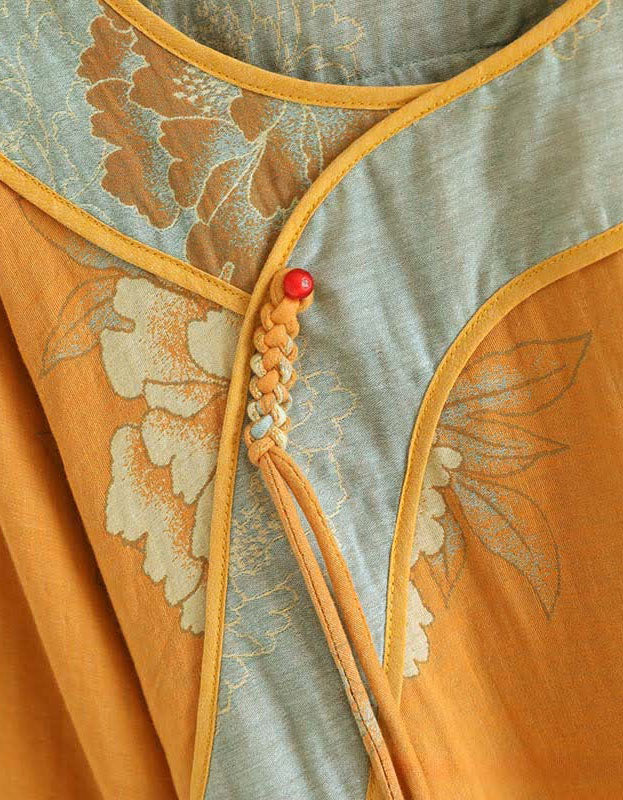 Close-up of the embroidered neckline and tie design on women’s mustard yellow floral top