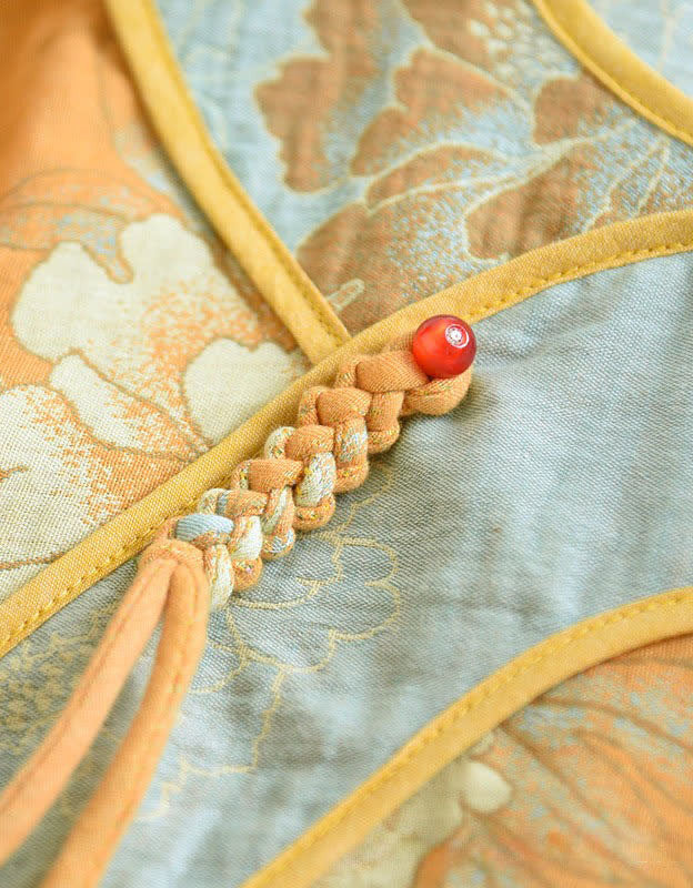 Close-up of floral embroidery on the women’s mustard yellow top, showcasing intricate stitching and vibrant design