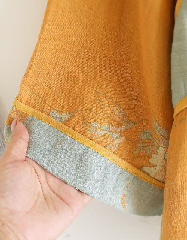 Detailed view of the floral embroidery on the soft cotton fabric of the mustard yellow top, highlighting the delicate craftsmanship