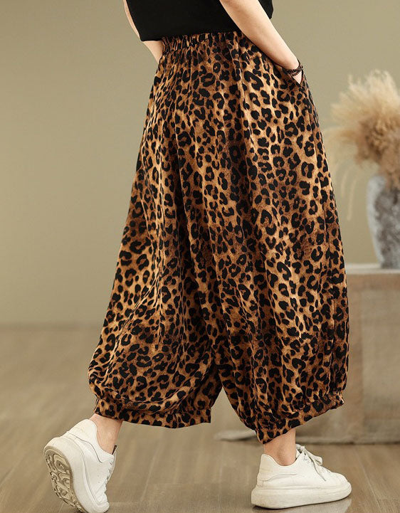 Back view of women’s leopard print wide-leg pants paired with white sneakers.