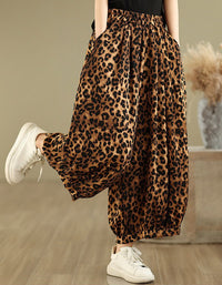 Side view of women’s leopard print wide-leg pants paired with white sneakers.