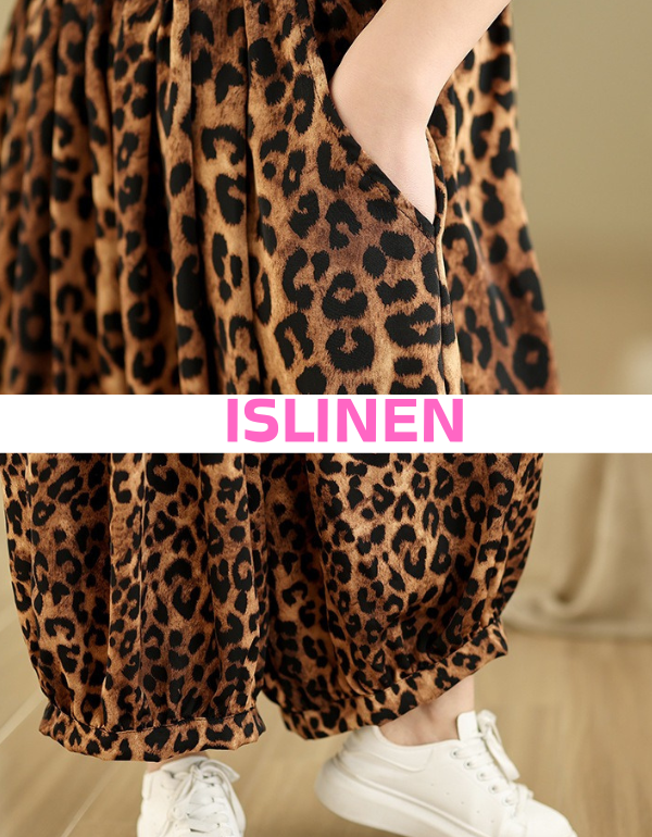 Close-up of women’s leopard print wide-leg pants paired with white sneakers.