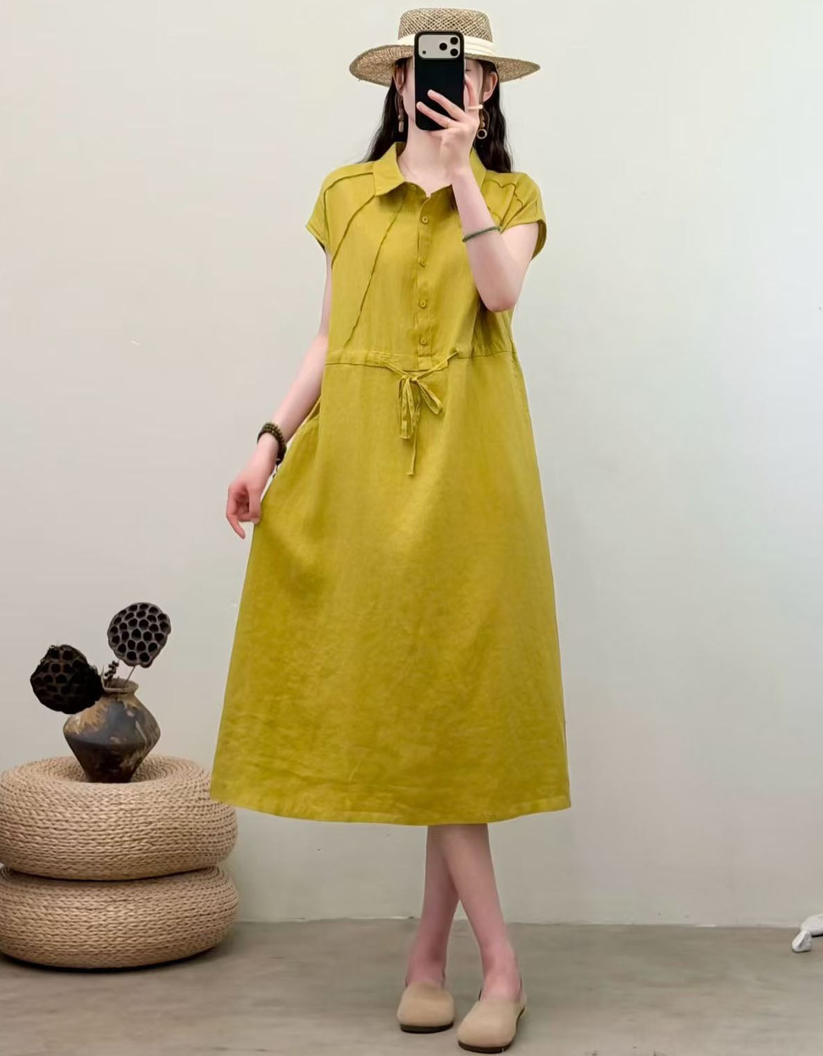Casual lightweight midi dress paired with straw hat for elegant summer fashion
