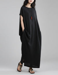 Women wearing loose grey linen maxi dress with side pockets