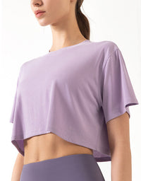 Person wearing a light purple crop top on a white background