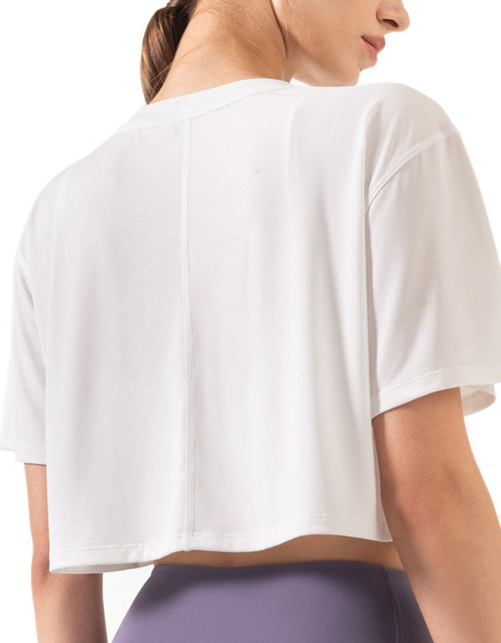 White crop top worn by a person on a white background back view