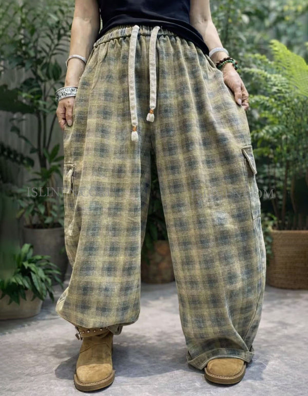 Oversized green plaid wide leg cargo pants with elastic drawstring waist, front view.