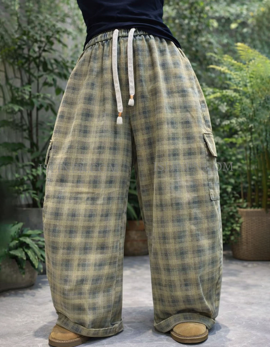 Wide leg green plaid cargo pants showing side flap pocket detail.