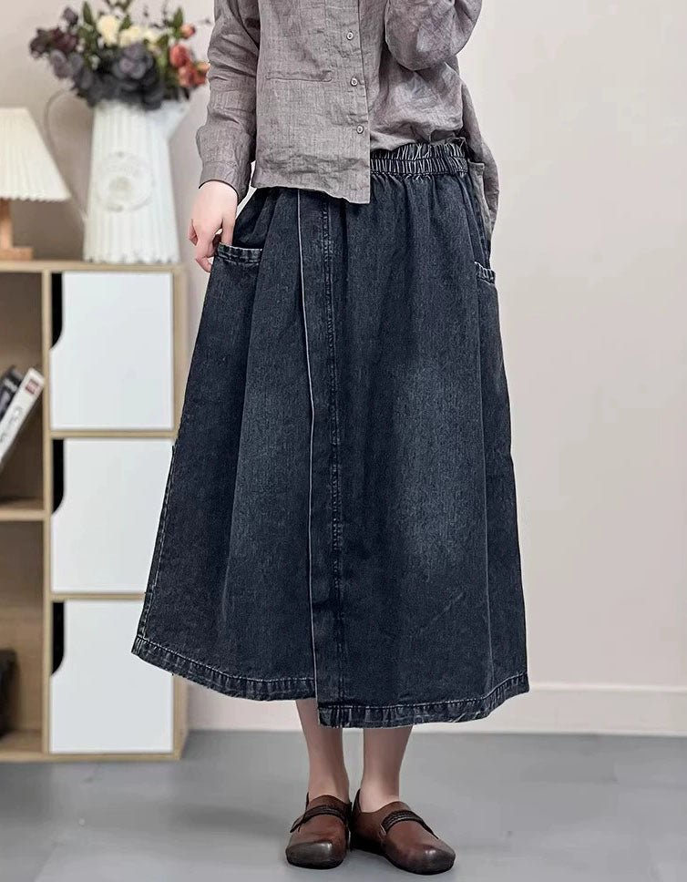 Dark wash A-line midi denim skirt with side pockets and elastic waistband.