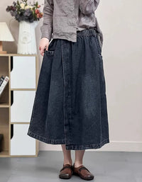 Dark wash A-line midi denim skirt with side pockets and elastic waistband.