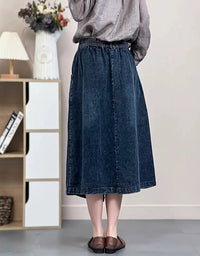Back view of vintage style denim skirt worn with flats