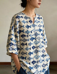 Women wearing relaxed blue fish linen top styled with wide leg pants