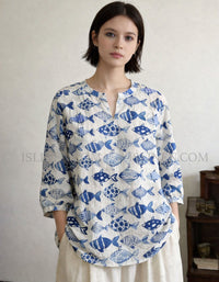 Front view of women’s blue fish pattern linen blouse with split neckline and 3/4 sleeves