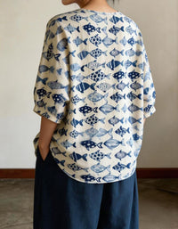 Back view of women’s blue fish print linen top with loose fit and 3/4 sleeves