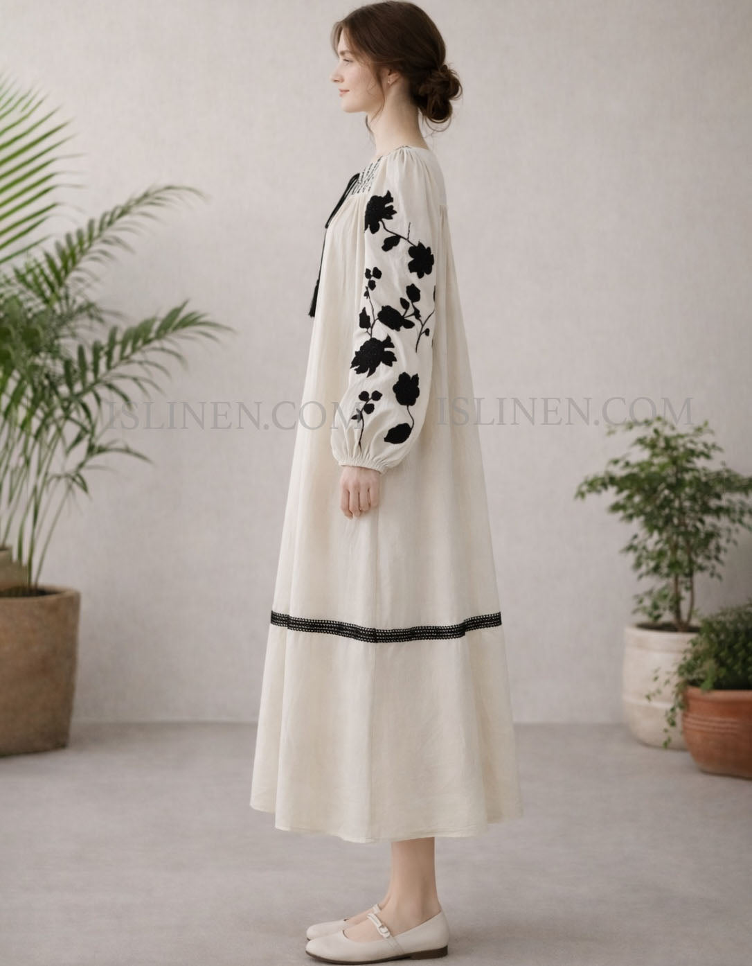 Boho style dress with black flower embroidery and tassel ties side view