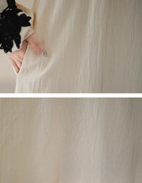 Close-up of boho-inspired dress with long sleeves and floral embroidery