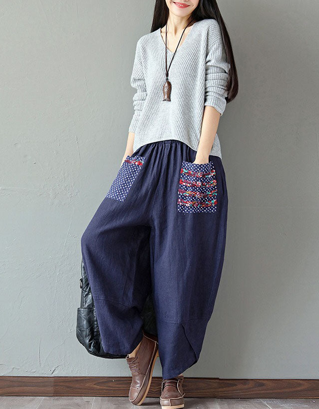 Women’s navy wide-leg pants styled with brown shoes and a casual sweater.