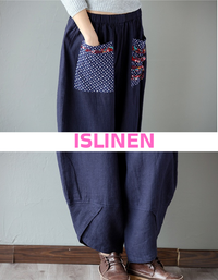 Close-up of the floral pocket design on navy linen harem pants.