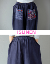 Detail of the floral pocket design on navy linen harem pants