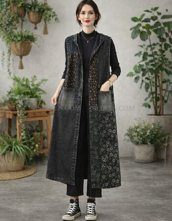 Woman wearing a long denim vest with floral pattern in a room with plants