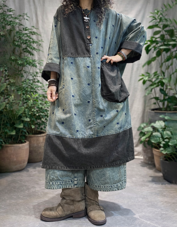 Side view of relaxed heart print denim maxi coat with dark hem panel and wide 3/4 sleeves.
